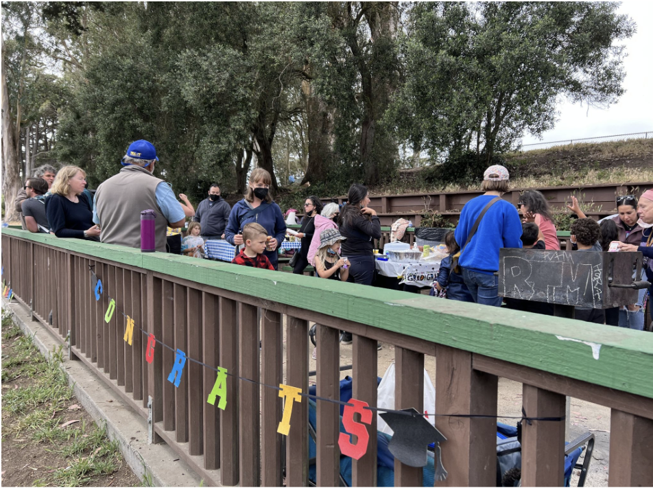 Families gathering for an end-of-year picnic